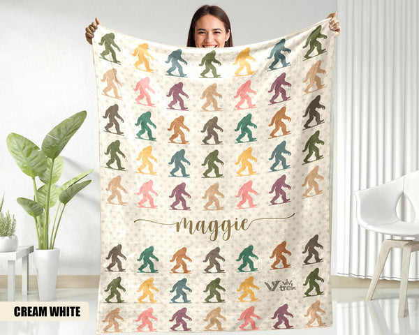 Person holding a blanket with colorful Bigfoot patterns and the name text on a background.