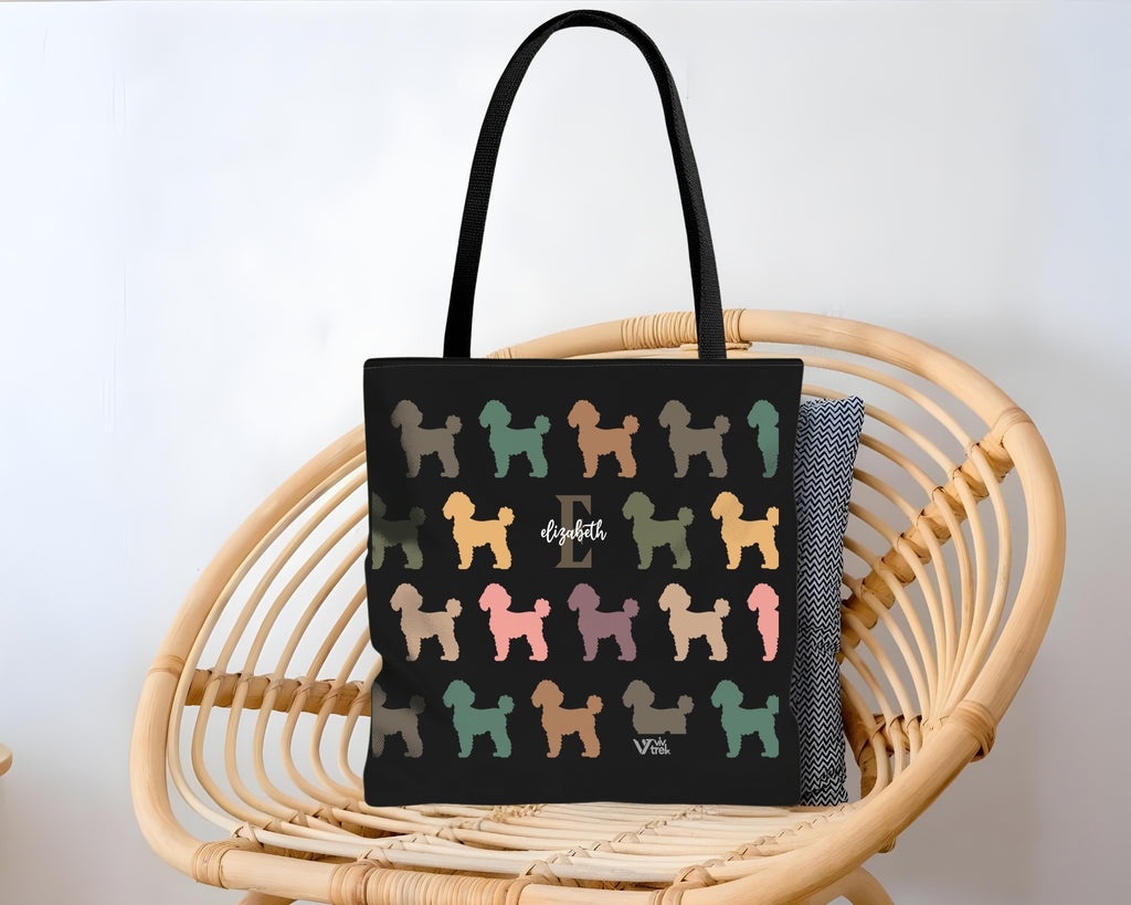 Black tote bag with colorful dog pattern and initial name text