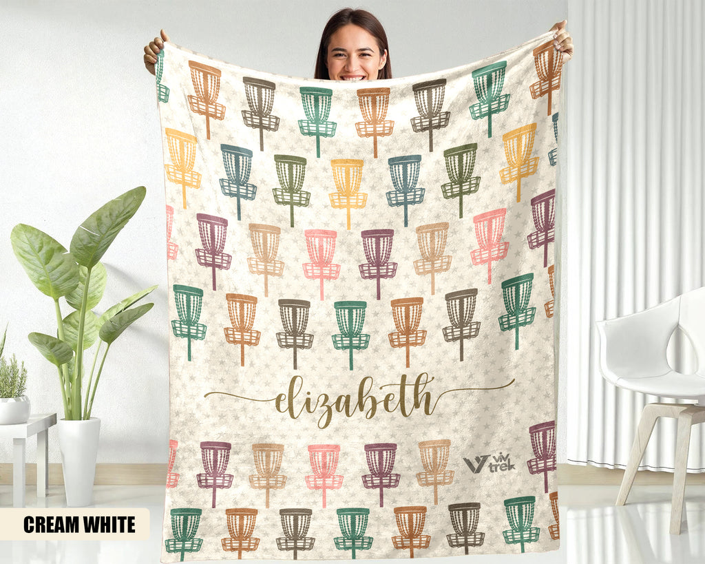 Person holding a blanket with disc golf disc pattern and name on a white background