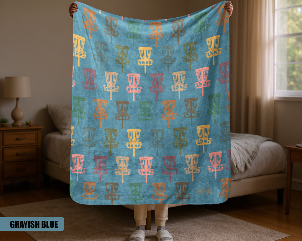 Person holding a colorful Disk golf patterned blanket in a bedroom