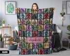 Person holding a colorful bigfoot blanket with patterns and name text in a room.