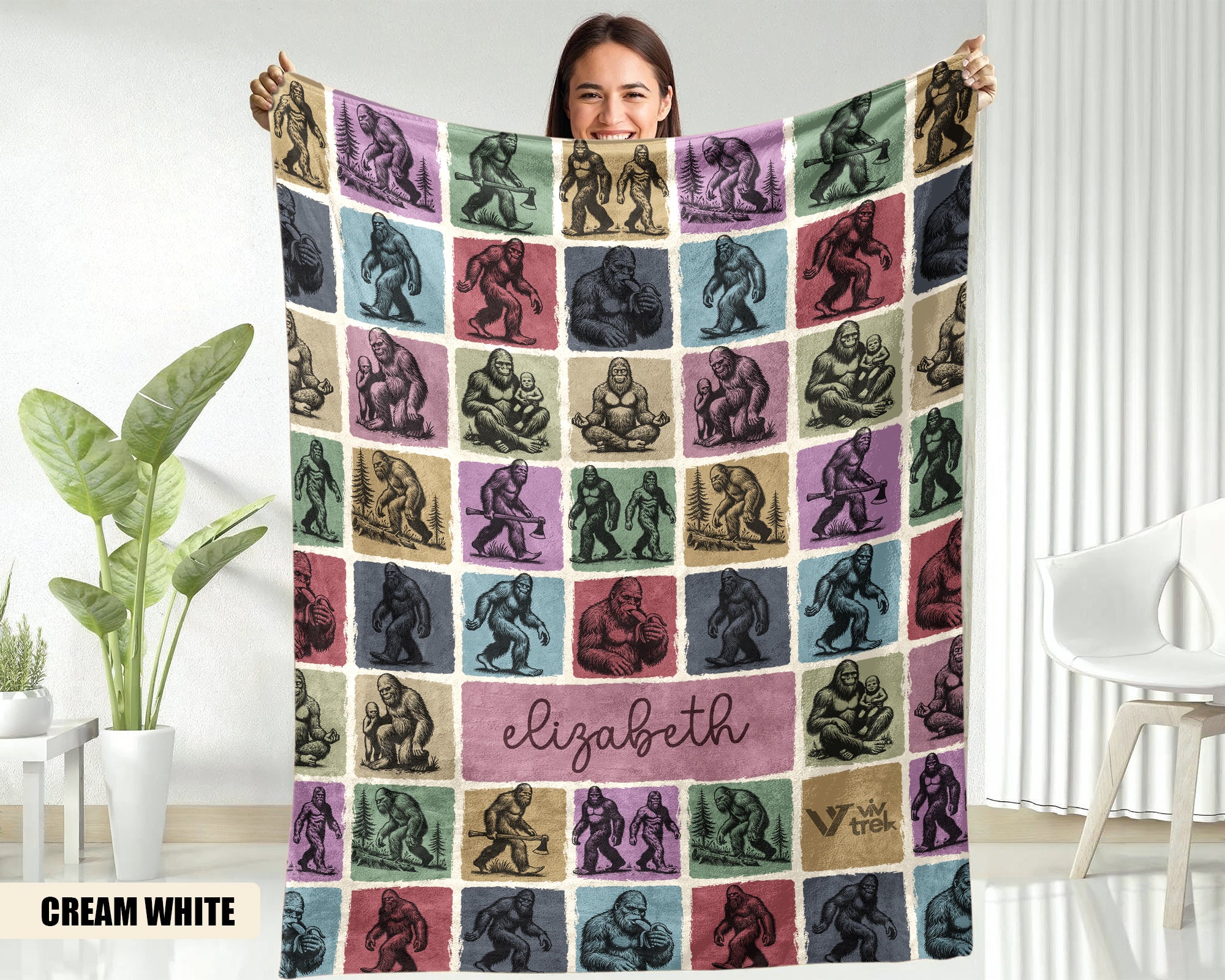 Person holding a colorful blanket with patterned design and name name in a room.