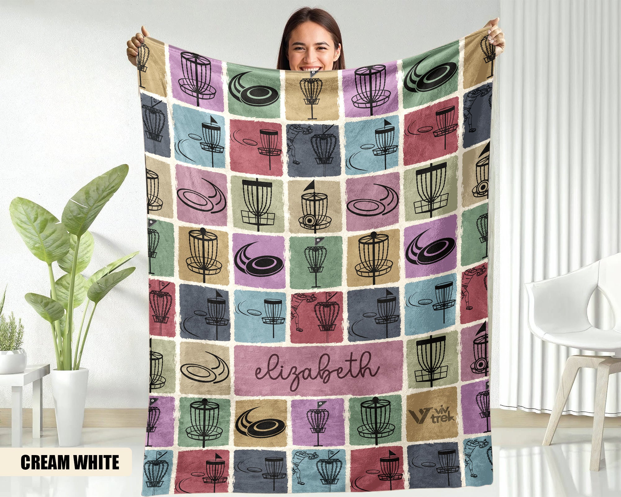 Person holding a colorful patterned blanket with text printed on it.