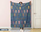 Person holding a decorative blanket with disc golf basket pattern and name text.