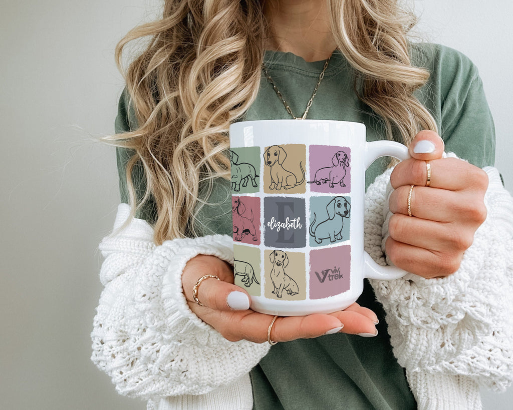 Person holding a mug with a design of dogs initial name and branding text 