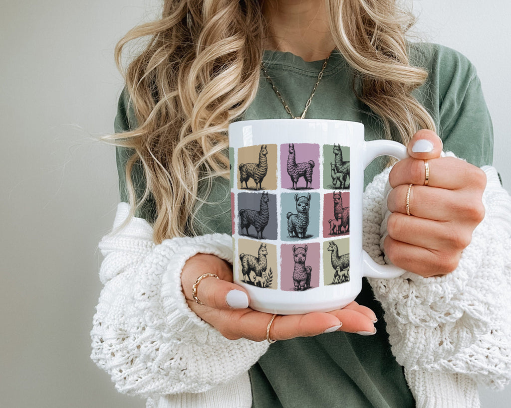 Person holding a mug with llama design.