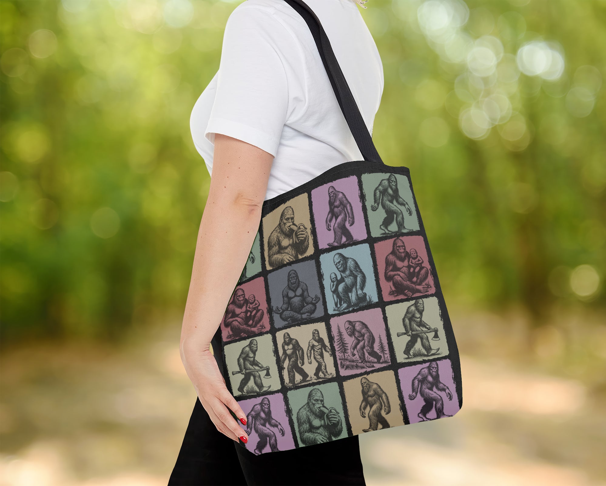 Person holding a tote bag with a pattern of stylized figures in various poses.