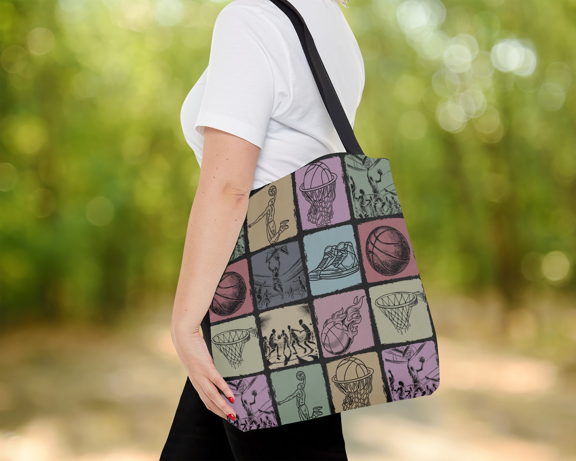 Person holding a tote bag with sports-themed Basketball design outdoors