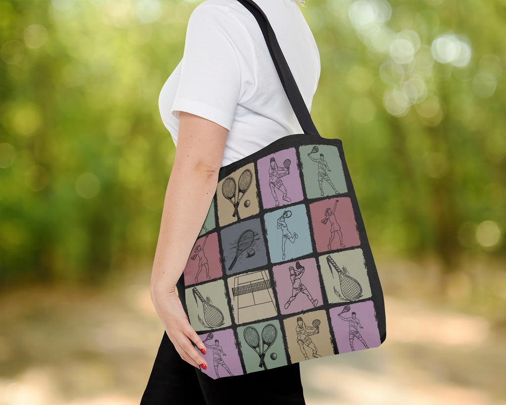 Person holding a tote bag with tennis-themed design outdoors